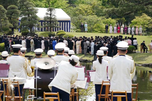 Japan's Emperor Naruhito (top, L) and Empress Masako (top, 2nd L), along with members of the royal family (top), attend the spring garden party at the Akasaka Palace's imperial garden in Tokyo on April 17, 2026. (Photo by Kazuhiro NOGI / POOL / AFP)