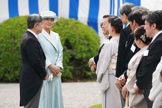 Japan's Emperor Naruhito (L) and Empress Masako (2nd L) greet guests during the spring garden party at the Akasaka Palace's imperial garden in Tokyo on April 17, 2026. (Photo by Kazuhiro NOGI / POOL / AFP)