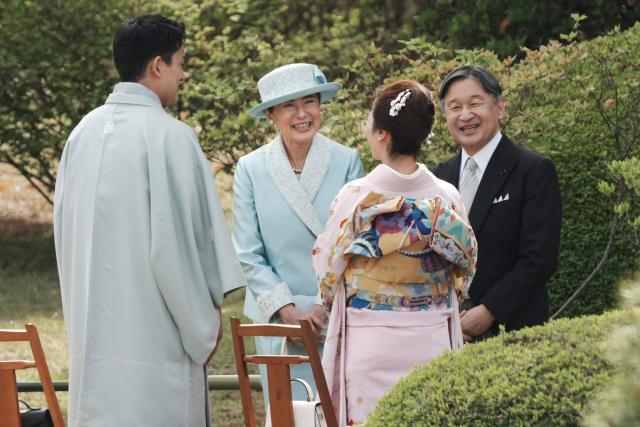 Japan's Emperor Naruhito (R) and Empress Masako (3rd R) chat with guests, Japanese Olympic figure skating pairs champions Riku Miura (2nd R) and Ryuichi Kihara (L), during the spring garden party at the Akasaka Palace's imperial garden in Tokyo on April 17, 2026. (Photo by Kazuhiro NOGI / POOL / AFP)