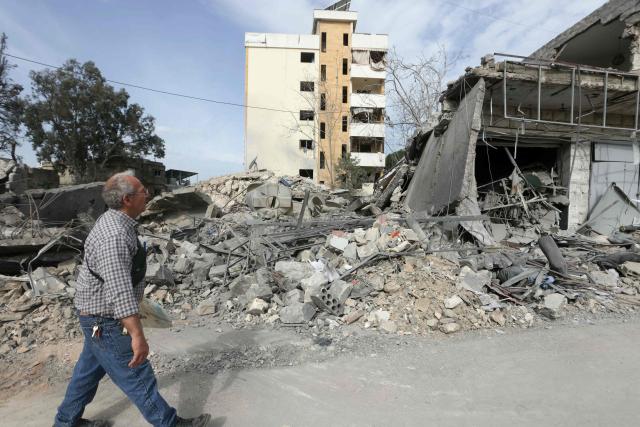 A resident inspects a destroyed building as he returns back to the southern Lebanese city of Nabatieh on April 17, 2026. A 10-day ceasefire deal struck between Lebanon and Israel took effect on April 17, sending displaced residents streaming south towards their homes, even as the Lebanese army warned of "a number of violations" in the area. (Photo by MAHMOUD ZAYYAT / AFP)
