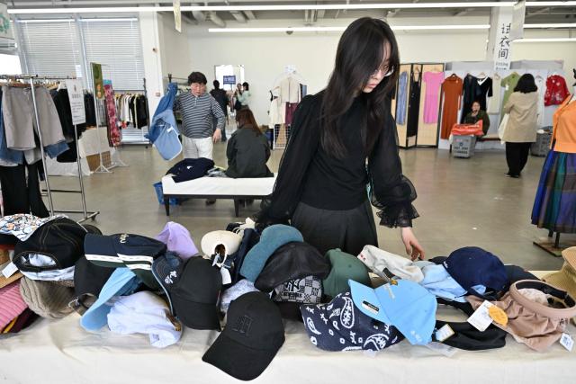 People visit a second-hand market in Beijing on April 17, 2026. (Photo by ADEK BERRY / AFP)