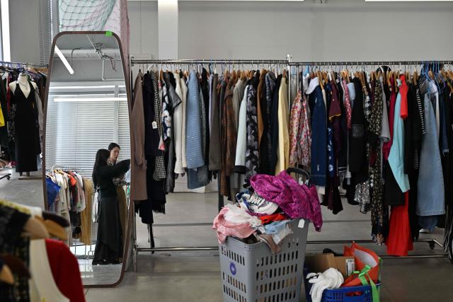People visit a second-hand market in Beijing on April 17, 2026. (Photo by ADEK BERRY / AFP)