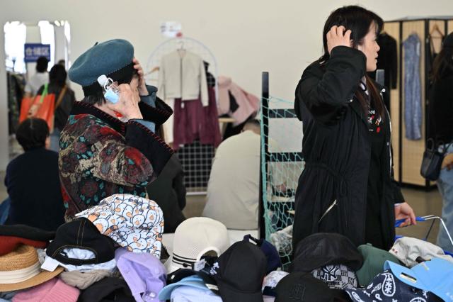 People visit a second-hand market in Beijing on April 17, 2026. (Photo by ADEK BERRY / AFP)