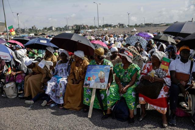 Faithfuls gather ahead of the Holy Mass to be lead by Pope Leo XIV at the area in front of Japoma Stadium in Douala on the fifth day of an 11-day apostolic journey to Africa, on April 17, 2026. (Photo by Patrick MEINHARDT / AFP)