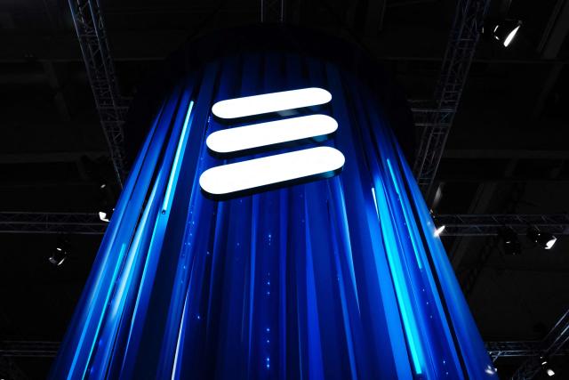 (FILES) This photograph shows the Swedish multinational networking and telecommunications company Ericsson's logo during the Mobile World Congress (MWC), the telecom industry's biggest annual gathering, in Barcelona on February 27, 2024. Swedish telecoms equipment maker Ericsson posted on April 17, 2026 a nearly 80 percent plunge in net profit as sales fell while the company faced rising costs and negative currency effects. The company reported net profit of 900 million kronor (USD 98 million) for the first quarter, down 79 percent from the period a year earlier, as revenues slid 10 percent to 49.3 billion kronor. The decline was especially pronounced in the Americas due to softening demand and uncertainty over customs duties, and was not offset by growth in other regions, Ericsson noted. (Photo by PAU BARRENA / AFP)