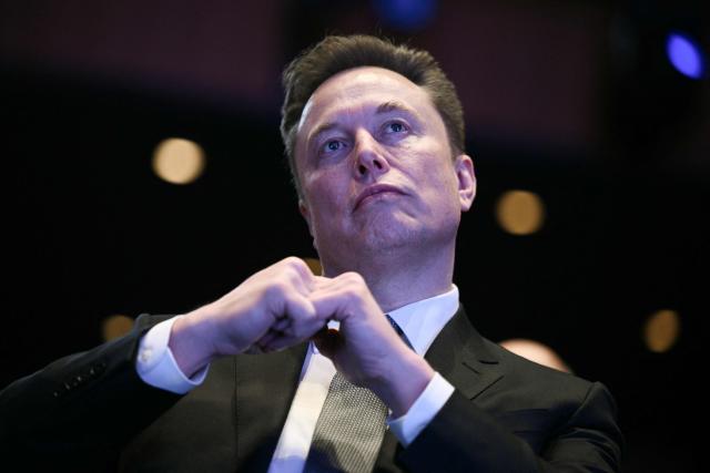 (FILES) Elon Musk looks on as US President Donald Trump speaks at the US-Saudi Investment Forum at the John F. Kennedy Center for the Performing Arts in Washington, DC on November 19, 2025. Elon Musk has been summoned on April 20, 2026 by the French courts as part of an investigation into alleged abuses on the social media platform X. (Photo by Brendan SMIALOWSKI / AFP)