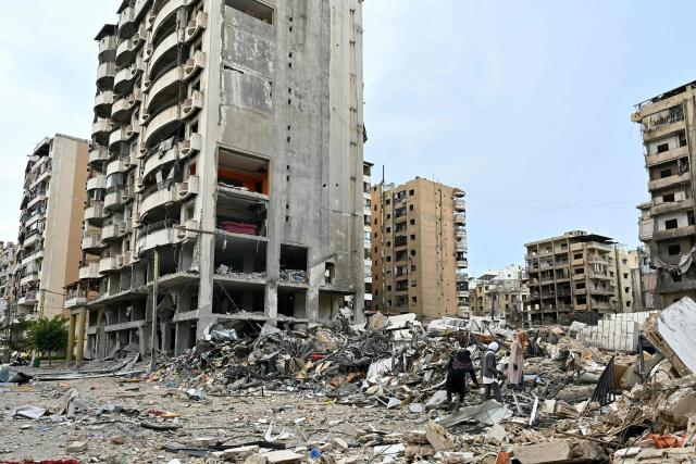 Lebanese women check destruction as they return to their neighbourhood in Beirut's southern suburbs after a 10-day ceasefire with Israel came into effect on April 17, 2026. A 10-day ceasefire deal struck between Lebanon and Israel took effect on April 17, sending displaced residents streaming south towards their homes, even as the Lebanese army warned of "a number of violations" in the area. (Photo by FADEL itani / AFP)