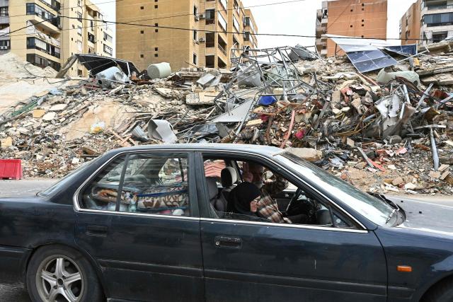 Lebanese residents returning to their neighbourhood drive past destruction in Beirut's southern suburbs after a 10-day ceasefire with Israel came into effect on April 17, 2026. A 10-day ceasefire deal struck between Lebanon and Israel took effect on April 17, sending displaced residents streaming south towards their homes, even as the Lebanese army warned of "a number of violations" in the area. (Photo by FADEL itani / AFP)