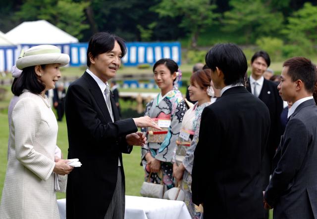 Japan's Crown Prince Akishino (C) and Crown Princess Kiko speak with Japanese medallists of the Milan Cortina Winter Olympics during the spring imperial garden party at the Akasaka Palace's imperial garden in Tokyo on April 17, 2026. (Photo by Franck ROBICHON / POOL / AFP)