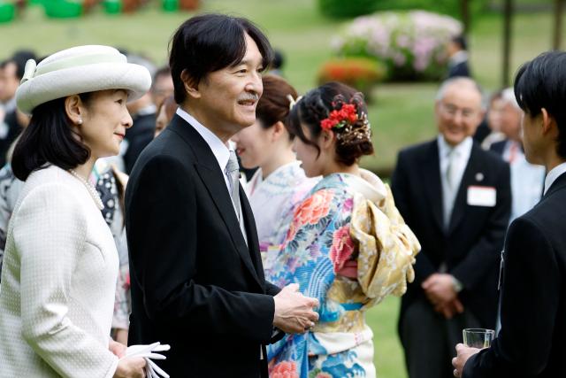 Japan's Crown Prince Akishino (C) and Crown Princess Kiko speak with Japanese medallists of the Milan Cortina Winter Olympics during the spring imperial garden party at the Akasaka Palace's imperial garden in Tokyo on April 17, 2026. (Photo by Franck ROBICHON / POOL / AFP)