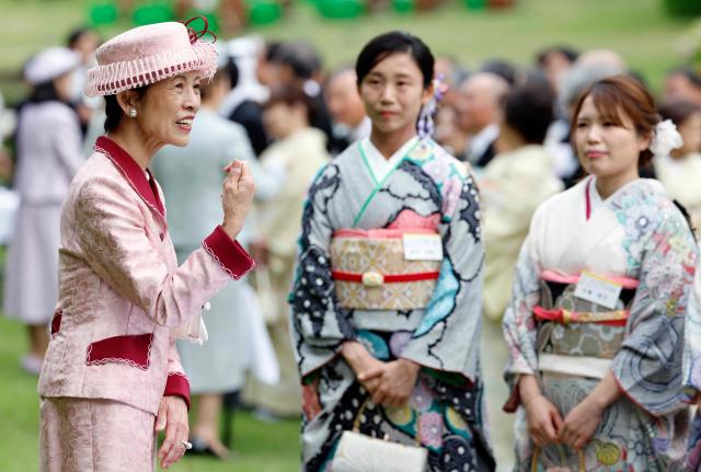 Japan's Princess Takamado (L) speaks with Japanese medallists of the Milan Cortina Winter Olympics during the spring imperial garden party at the Akasaka Palace's imperial garden in Tokyo on April 17, 2026. (Photo by Franck ROBICHON / POOL / AFP)