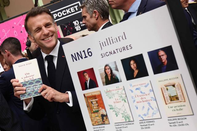 French President Emmanuel Macronvisits the Paris Book Fair at the Grand Palais in Paris on April 17, 2026. The fair, which runs until April 19, spotlights comic books as its central theme. (Photo by Teresa SUAREZ / POOL / AFP)