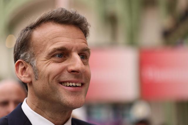French President Emmanuel Macron visits the Paris Book Fair at the Grand Palais in Paris on April 17, 2026. The fair, which runs until April 19, spotlights comic books as its central theme. (Photo by Teresa SUAREZ / POOL / AFP)