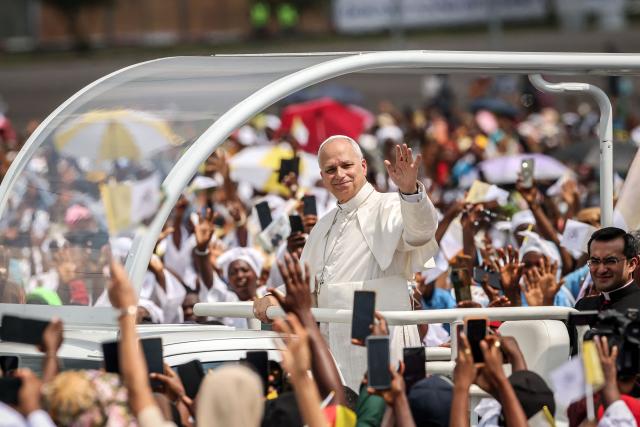 Pope Leo XIV (C) waves to the crowd from the Popemobile as he arrives to lead the Holy Mass at the area in front of Japoma Stadium in Douala on the fifth day of an 11-day apostolic journey to Africa, on April 17, 2026. (Photo by Daniel Beloumou Olomo / AFP)