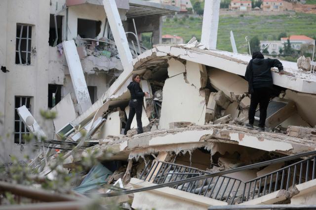 Women inspect destruction of their house upon their return to the southern Lebanese city of Nabatieh on April 17, 2026. Thousands of displaced Lebanese civilians took to the road on April 17, hoping that a 10-day ceasefire with Israel would allow them to return to their homes in southern Beirut and the country's war-torn south. (Photo by ibrahim AMRO / AFP)