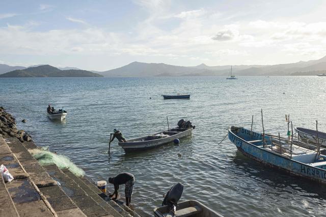 (FILES) Fishermen drive boats in Dzaoudzi, on the island of Mayotte, on April 29, 2023. Since November 2025, many of the island’s fishermen have stopped going out to sea. Most own motorised boats that do not comply with European standards, but which had until then allowed them, under a prefectural exemption, to fish as far as the fish-rich Zйlйe Bank, 110 kilometres northeast of Mayotte. The exemption was not renewed. (Photo by Patrick Meinhardt / AFP)