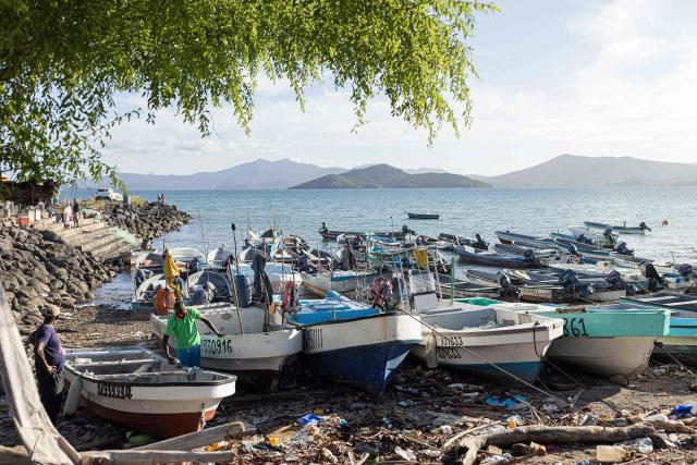 (FILES) Fishermen work next to boats in Dzaoudzi, on the island of Mayotte, on April 29, 2023. Since November 2025, many of the island’s fishermen have stopped going out to sea. Most own motorised boats that do not comply with European standards, but which had until then allowed them, under a prefectural exemption, to fish as far as the fish-rich Zйlйe Bank, 110 kilometres northeast of Mayotte. The exemption was not renewed. (Photo by Patrick Meinhardt / AFP)