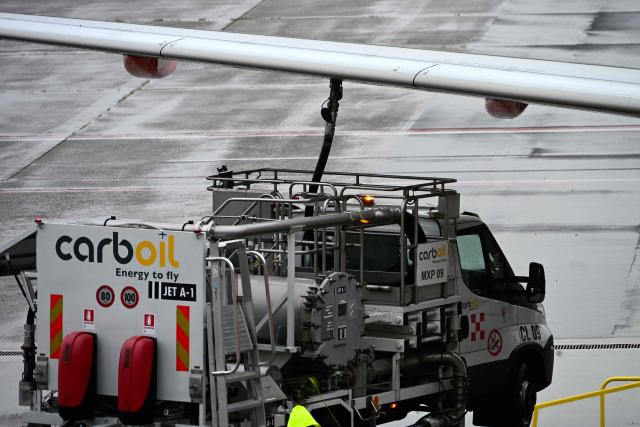 A fuel truck "CarbOil" services an Easyjet aircraft at Milan's Malpensa Airport on April 13, 2026. The European Commission said April 14, 2026 it fears Europe could face jet fuel supply issues "in the near future" with no end in sight to the Iran war roiling global energy markets. (Photo by Stefano Rellandini / AFP)