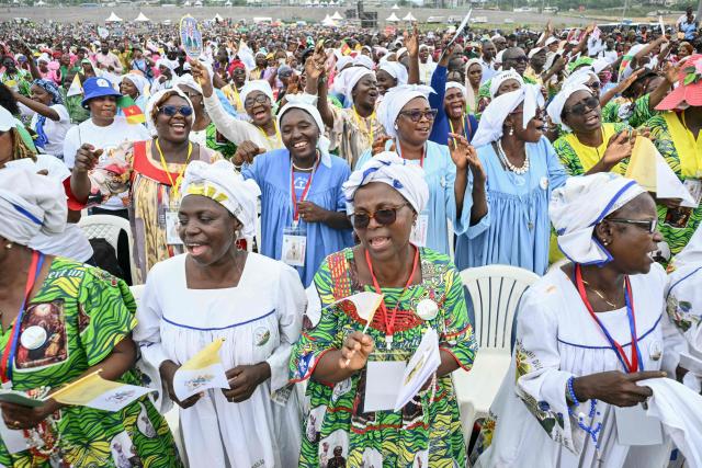 Faithfuls sing as Pope Leo XIV leads the Holy Mass at the area in front of Japoma Stadium in Douala on the fifth day of an 11-day apostolic journey to Africa, on April 17, 2026. (Photo by Alberto PIZZOLI / AFP)