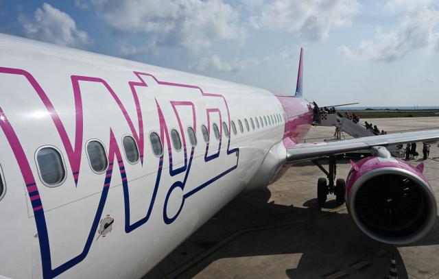 (FILES) This photograph shows a Wizz air jet on the tarmac of at the Lampedusa airport, on August 17, 2025. Hungarian low-cost airline Wizz Air has encountered some jet fuel shortages at three airports in Italy, its chief executive said on April 17, 2026, following warnings about supplies because of the blockage of the Strait of Hormuz. (Photo by Stefano RELLANDINI / AFP)