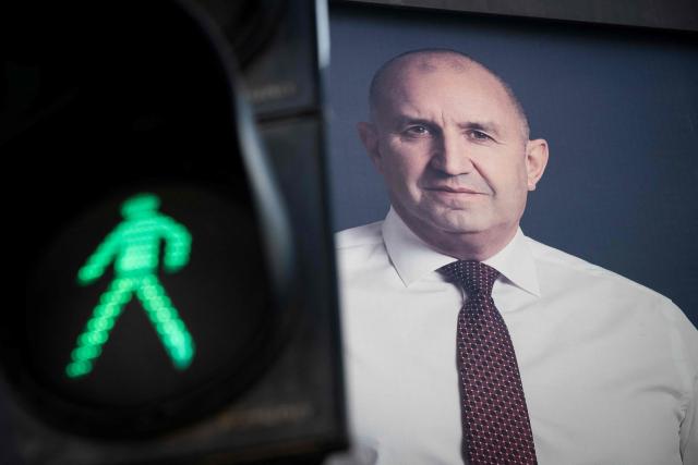 An electoral billboard of Progressive Bulgaria coalition leader and former president Rumen Radev is pictured next to a traffic light in Sofia on April 17, 2026. Bulgaria will hold its eighth general election in five years on April 19, 2026, with ex-president Rumen Radev's new grouping tipped to win a ballot many hope will end chronic instability. (Photo by Nikolay DOYCHINOV / AFP)