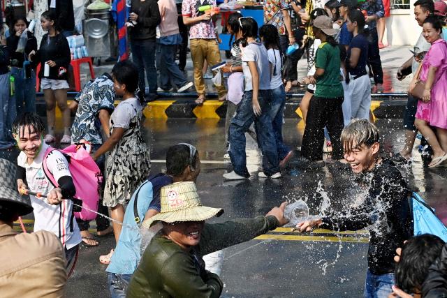 Revellers take part in mass water fights during celebrations for the Khmer New Year, known as Nokor Sankranta, in Phnom Penh on April 17, 2026. (Photo by TANG CHHIN Sothy / AFP)
