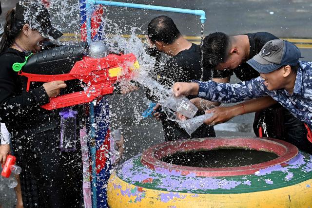 Revellers take part in mass water fights during celebrations for the Khmer New Year, known as Nokor Sankranta, in Phnom Penh on April 17, 2026. (Photo by TANG CHHIN Sothy / AFP)