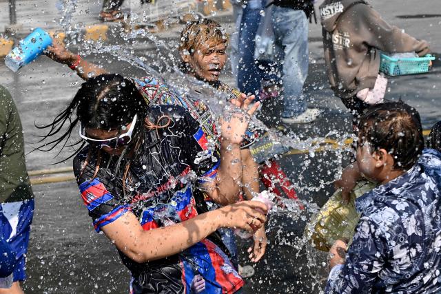 Revellers take part in mass water fights during celebrations for the Khmer New Year, known as Nokor Sankranta, in Phnom Penh on April 17, 2026. (Photo by TANG CHHIN Sothy / AFP)