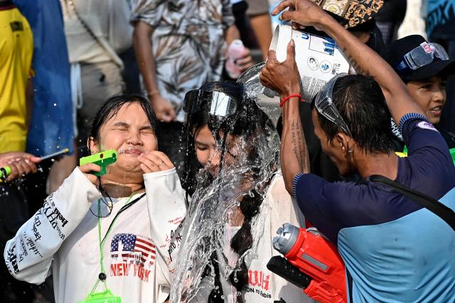 Revellers take part in mass water fights during celebrations for the Khmer New Year, known as Nokor Sankranta, in Phnom Penh on April 17, 2026. (Photo by TANG CHHIN Sothy / AFP)