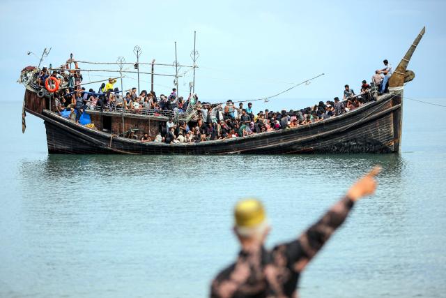 (FILES) Newly arrived Rohingya refugees are stranded on a boat after the nearby community decided not to allow them to land after giving them water and food in Pineung, Aceh province on November 16, 2023. Last year was the deadliest on record for Rohingya refugees fleeing by sea, with nearly 900 reported dead or missing in shipwrecks in the region, the United Nations said on April 17, 2026. (Photo by amanda jufrian / AFP) / To go with AFP story Indonesia-Bangladesh-Myanmar-Royingya-refugee, FOCUS by Mulyadi and Marchio Gorbiano