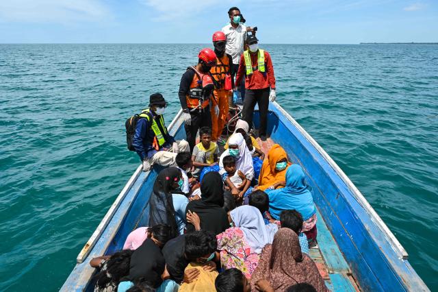 (FILES) Search and rescue members evacuate Rohingya refugees from a boat after a week anchored ashore off the coast of Labuhan Haji in Southern Aceh province on October 24, 2024. Last year was the deadliest on record for Rohingya refugees fleeing by sea, with nearly 900 reported dead or missing in shipwrecks in the region, the United Nations said on April 17, 2026. (Photo by CHAIDEER MAHYUDDIN / AFP)