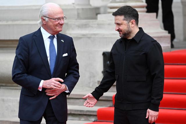 Ukraine's President Volodymyr Zelensky (R) greets Sweden's King Carl XVI Gustaf (L) prior to their talks in Lviv on April 17, 2026, amid the Russian invasion of Ukraine. (Photo by YURIY DYACHYSHYN / AFP)