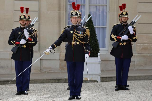 French Republican Guard stand to attention in the courtyard at the presidential Elysee Palace in Paris on April 17, 2026. (Photo by Ludovic MARIN / AFP)