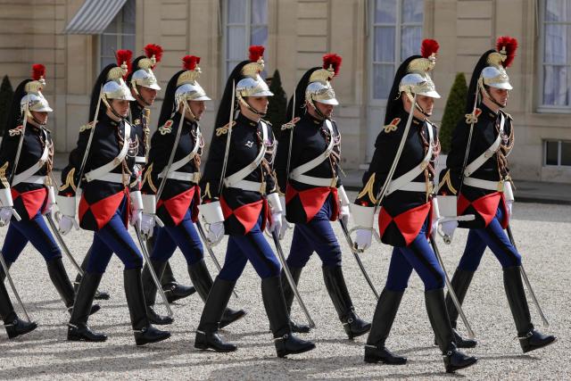 French Republican Guard march in the courtyard at the presidential Elysee Palace in Paris on April 17, 2026. (Photo by Ludovic MARIN / AFP)