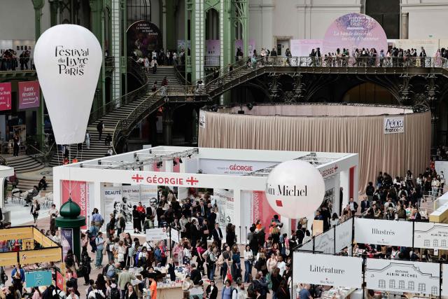 People visit the Paris Book Fair at the Grand Palais in Paris on April 17, 2026. The fair, which runs until April 19, spotlights comic books as its central theme. (Photo by STEPHANE DE SAKUTIN / AFP)