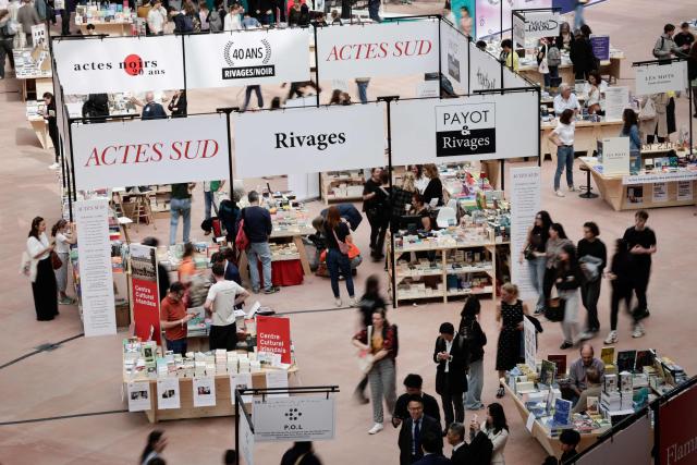 People visit the Paris Book Fair at the Grand Palais in Paris on April 17, 2026. The fair, which runs until April 19, spotlights comic books as its central theme. (Photo by STEPHANE DE SAKUTIN / AFP)