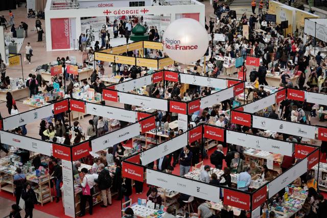 People visit the Paris Book Fair at the Grand Palais in Paris on April 17, 2026. The fair, which runs until April 19, spotlights comic books as its central theme. (Photo by STEPHANE DE SAKUTIN / AFP)