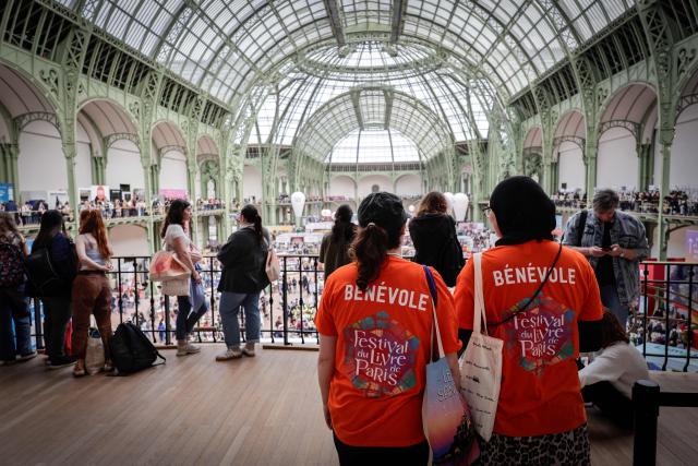 People visit the Paris Book Fair at the Grand Palais in Paris on April 17, 2026. The fair, which runs until April 19, spotlights comic books as its central theme. (Photo by STEPHANE DE SAKUTIN / AFP)