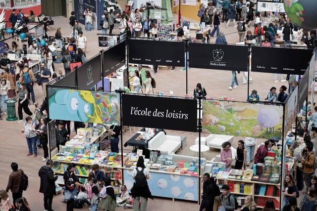 People visit the Paris Book Fair at the Grand Palais in Paris on April 17, 2026. The fair, which runs until April 19, spotlights comic books as its central theme. (Photo by STEPHANE DE SAKUTIN / AFP)