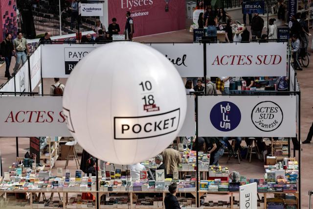 People visit the Paris Book Fair at the Grand Palais in Paris on April 17, 2026. The fair, which runs until April 19, spotlights comic books as its central theme. (Photo by STEPHANE DE SAKUTIN / AFP)