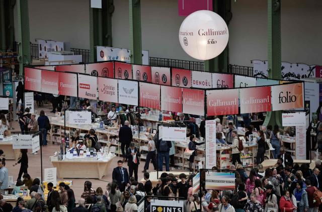 People visit the Paris Book Fair at the Grand Palais in Paris on April 17, 2026. The fair, which runs until April 19, spotlights comic books as its central theme. (Photo by STEPHANE DE SAKUTIN / AFP)