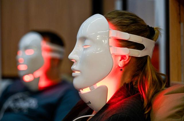 Visitors wear the Myblend myLEDmask2 "Anti-Aging" product at the FIBO trade show for health, fitness and wellness in Cologne, western Germany on April 17, 2026. (Photo by Ina FASSBENDER / AFP)