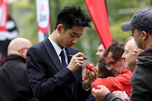 Chinese snooker player Wu Yize signs a snooker ball during a media day launching the start of the World Snooker Championship 2026 at Crucible Theatre in Sheffield, northern England, on April 17, 2026. (Photo by Darren Staples / AFP)