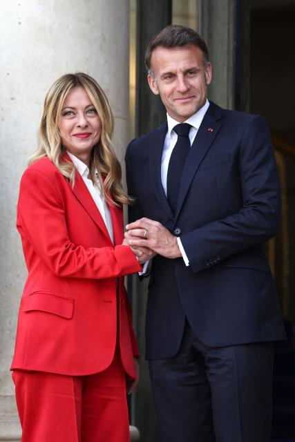 France's President Emmanuel Macron (R) welcomes Italy's Prime Minister Giorgia Meloni (L) ahead of a meeting of allies to consider sending a multinational force to ensure security and free-flowing trade in the Strait of Hormuz, at the presidential Elysee Palace in Paris on April 17, 2026. French President Emmanuel Macron and UK Prime Minister Keir Starmer chair a meeting of allies to consider sending a multinational force to ensure security and free-flowing trade in the Strait of Hormuz once the current conflict between Iran and the US and Israel ends. Iran imposed the blockade on the critical shipping bottleneck as soon as the US and Israel launched the war against the Islamic republic on February 28, leading to a surge in global energy prices. Even with a shaky ceasefire in place, the US is now imposing its own blockade on Iranian ports. (Photo by Tom Nicholson / POOL / AFP)