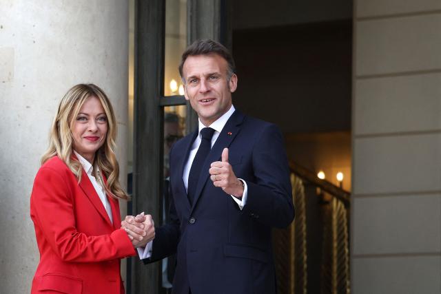 France's President Emmanuel Macron (R) welcomes Italy's Prime Minister Giorgia Meloni (L) ahead of a meeting of allies to consider sending a multinational force to ensure security and free-flowing trade in the Strait of Hormuz, at the presidential Elysee Palace in Paris on April 17, 2026. French President Emmanuel Macron and UK Prime Minister Keir Starmer chair a meeting of allies to consider sending a multinational force to ensure security and free-flowing trade in the Strait of Hormuz once the current conflict between Iran and the US and Israel ends. Iran imposed the blockade on the critical shipping bottleneck as soon as the US and Israel launched the war against the Islamic republic on February 28, leading to a surge in global energy prices. Even with a shaky ceasefire in place, the US is now imposing its own blockade on Iranian ports. (Photo by Tom Nicholson / POOL / AFP)