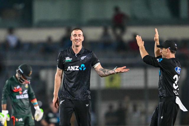 New Zealand's Blair Tickner (C) celebrates with teammates after taking the wicket of Bangladesh's captain Mehidy Hasan Miraz during the first one-day international (ODI) cricket match between Bangladesh and New Zealand at Sher-e-Bangla National Stadium in Mirpur on April 17, 2026. (Photo by Munir UZ ZAMAN / AFP)