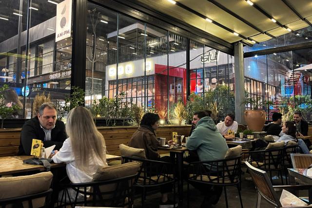 TOPSHOT - Patrons sit in a cafe in Tehran on April 14, 2026. Iran's foreign ministry welcomed the truce agreed between Israel and Lebanon, calling it part of the earlier two-week ceasefire deal struck between the Islamic republic and the United States to pause the Middle East war, state media reported. (Photo by AFP)