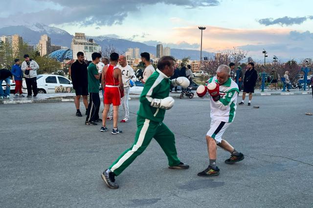 People practice boxing at Pardisan Park in Tehran on April 14, 2026. Iran's foreign ministry welcomed the truce agreed between Israel and Lebanon, calling it part of the earlier two-week ceasefire deal struck between the Islamic republic and the United States to pause the Middle East war, state media reported. (Photo by AFP)