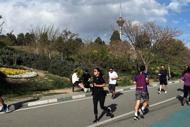 TOPSHOT - People jogs at Pardisan Park in Tehran on April 14, 2026. Iran's foreign ministry welcomed the truce agreed between Israel and Lebanon, calling it part of the earlier two-week ceasefire deal struck between the Islamic republic and the United States to pause the Middle East war, state media reported. (Photo by AFP)