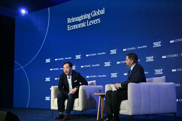 Eric Xing (L), US computer scientist and President of Mohamed bin Zayed University of Artificial Intelligence, speaks during the 2026 Semafor World Economy conference in Washington, DC, on April 17, 2026. (Photo by Mandel NGAN / AFP)